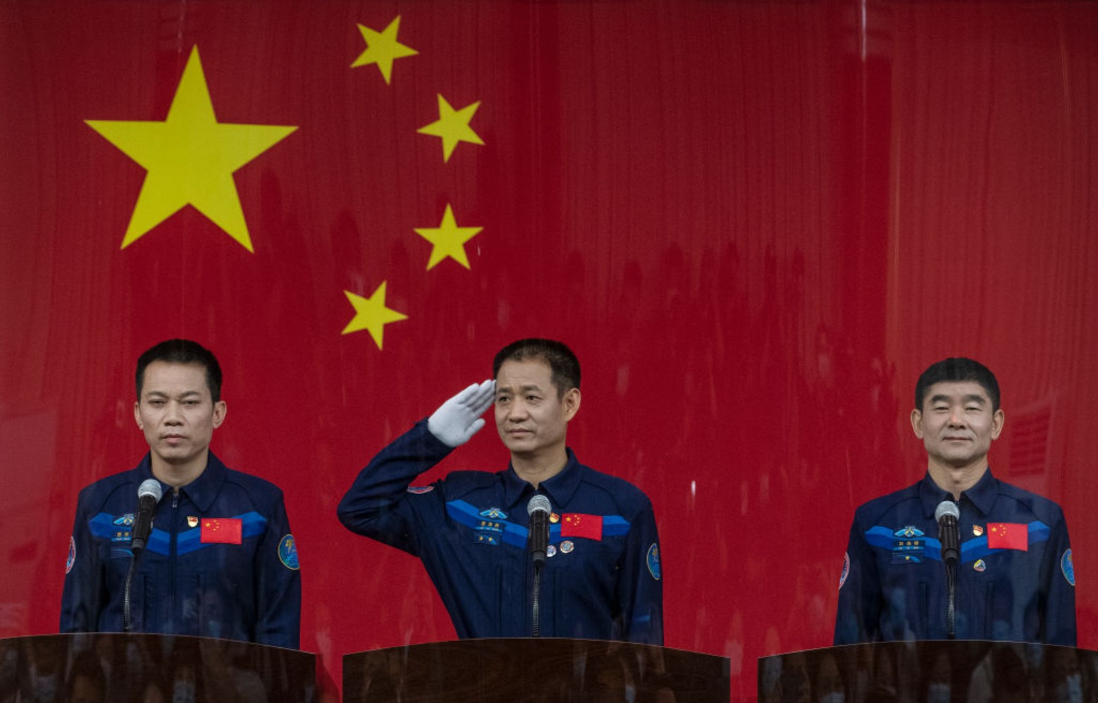 Chinese astronauts Tang Hongbo, Nie Haisheng, and Liu Boming at a press conference