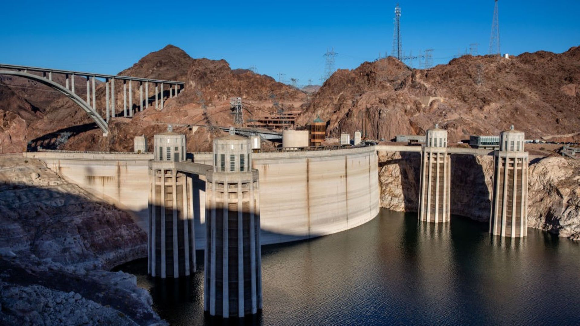 A photo of the Hoover Dam with a very low water level. The water level is so low that the intake towers are exposed