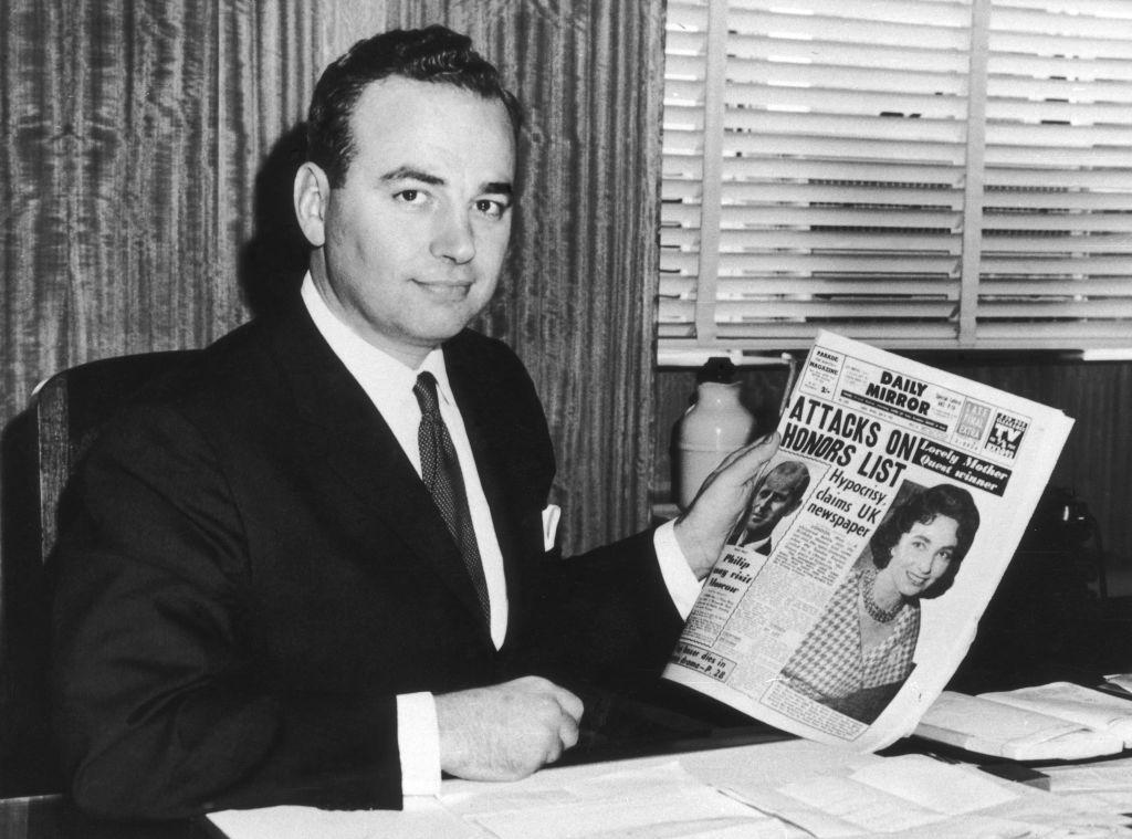 Young Rupert Murdoch poses with his newspaper