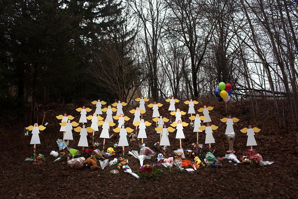 Twenty-seven wooden angel figures placed beside the road in Sandy Hook after the mass shooting