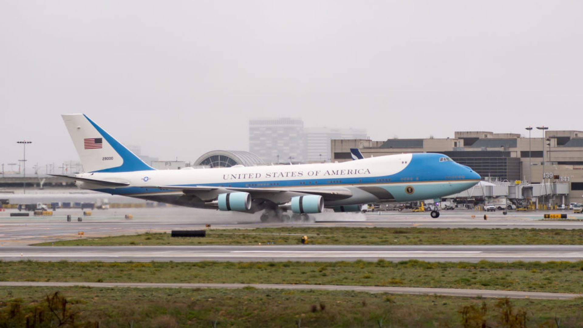 Air Force One on Tarmac. The words 'UNITED STATES OF AMERICA' are prominently displayed on its fuselage