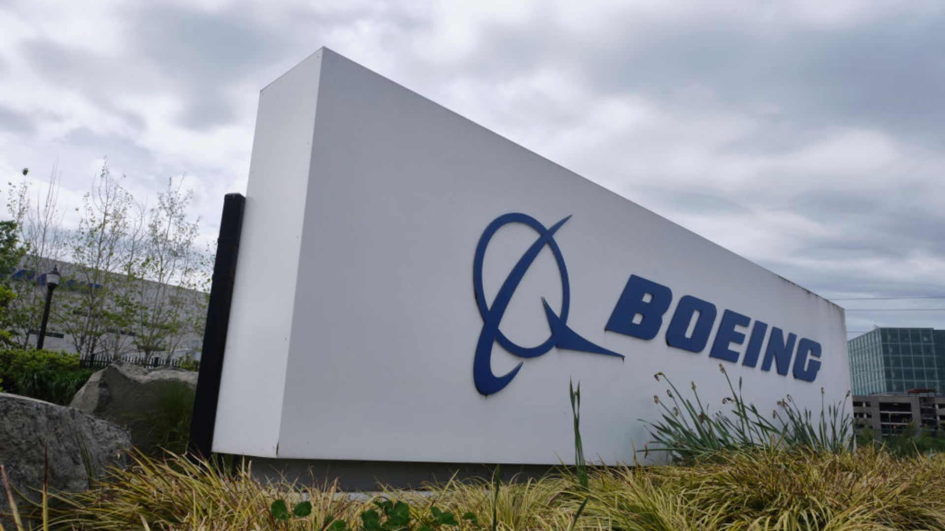 A large white sign with the blue Boeing logo and text prominently displayed