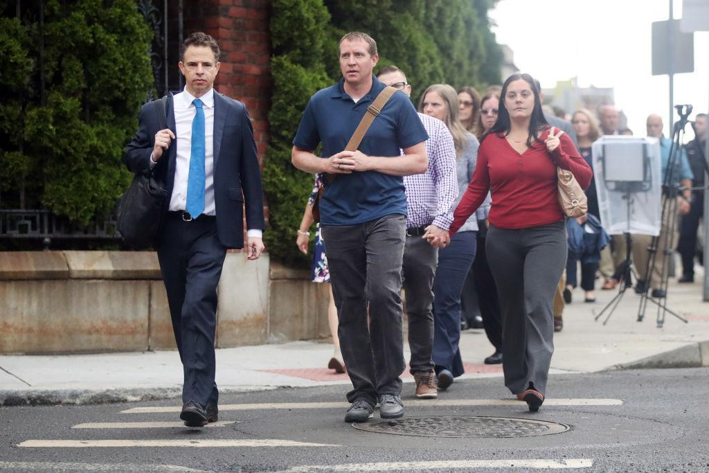 Families of Sandy Hook Elementary School shooting victims walk into Waterbury Superior Court with their lead lawyer, Josh Koskoff