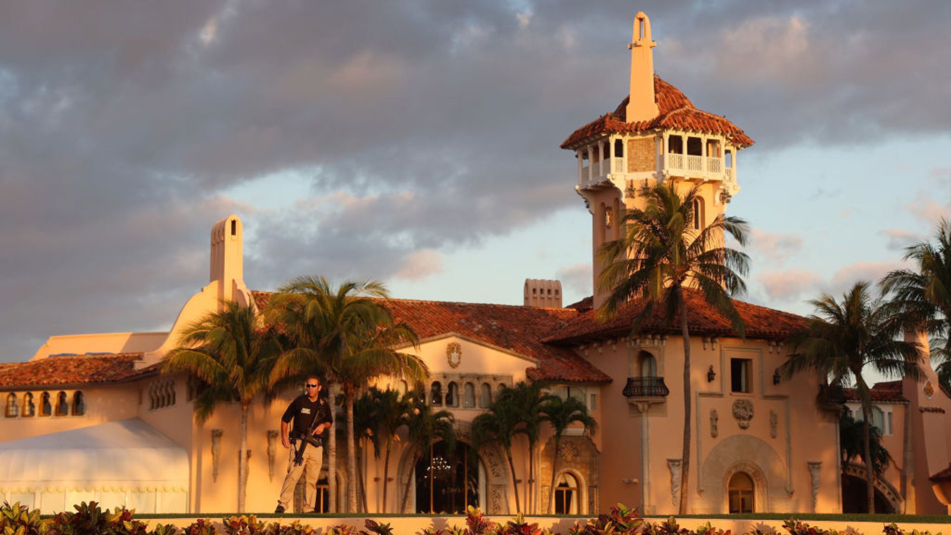 A warm sunset casts golden hues over the Mar-a-Lago estate, highlighting its intricate architectural details