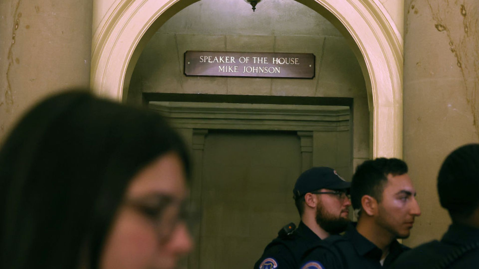 An image showing the top part of a door with a sign that reads "SPEAKER OF THE HOUSE MIKE JOHNSON."
