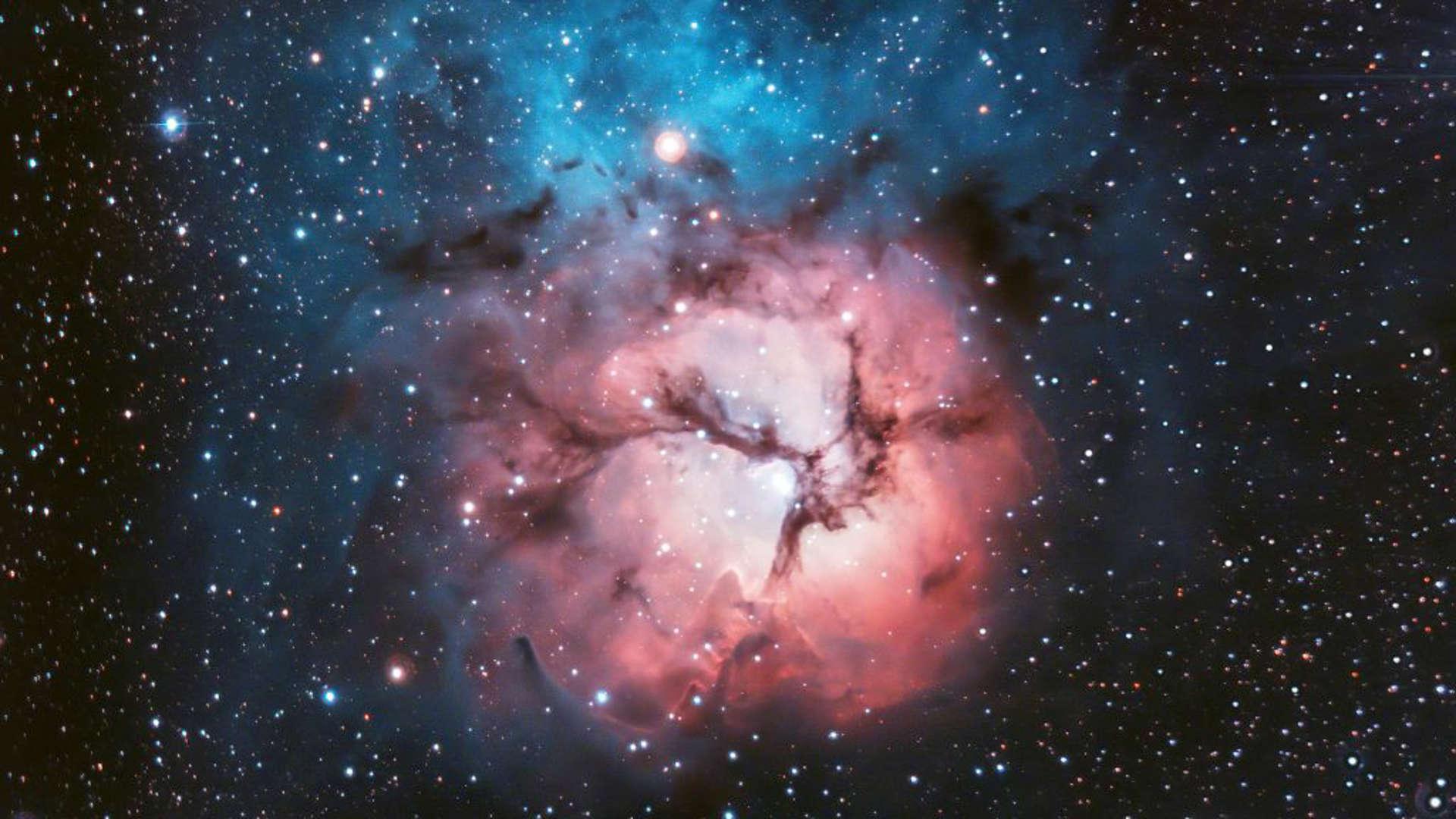 Beautiful bright space nebula with stars and galaxies around it.