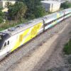 An image of a Brightline train traveling along the tracks in Florida