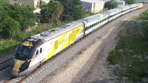 An image of a Brightline train traveling along the tracks in Florida
